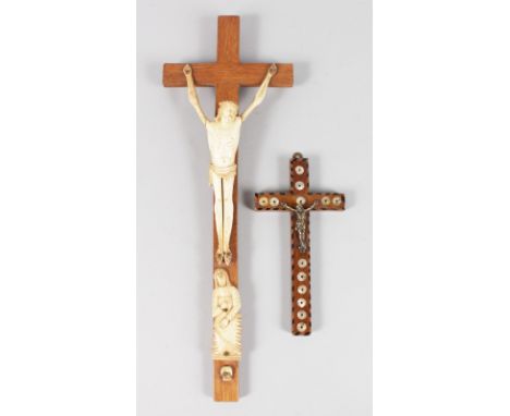 TWO CRUCIFIXES, one bone, the other inlaid with mother-of-pearl. 16ins long and 7ins long.