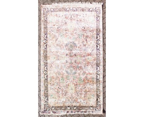 A SILK KASHMIR RUG, pink ground with hunting scenes and leopards. 8ft x 5ft 9ins.