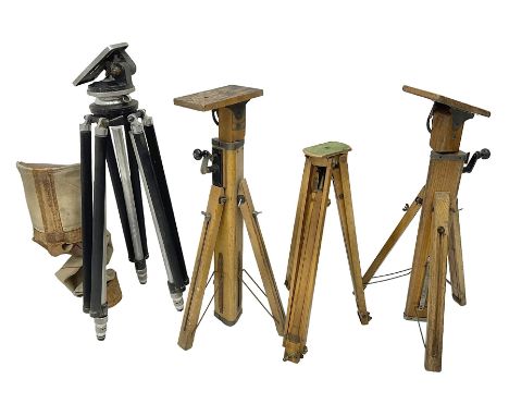 Three wooden adjustable tripods for plate cameras, together with a Linhof of Munchen metal tripod in a canvas case 