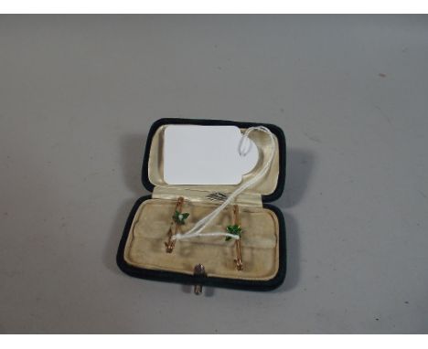 A Enamelled Gold Metal Safety Pins, One with Missing Pearl 
