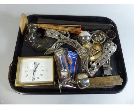 A Tray of Curios to Include Silver Plated Napkin Rings and Goblet, Oriental Fan, Souvenir Tea Spoons, Carriage Clock Etc