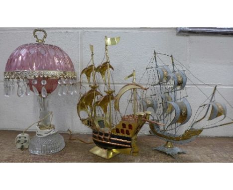 A metal, brass and copper novelty galleon table lamp, a pink glass table lamp and a brass model of a galleon