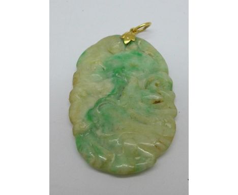 A late 19th Century carved jade pendant, 56mm x 34mm