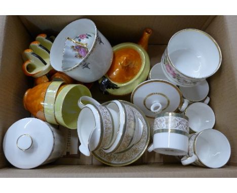 A set of eight Minton Aragon coffee cups, saucers, cream and sugar, an orange Art Deco part tea set with Carlton Ware toast r