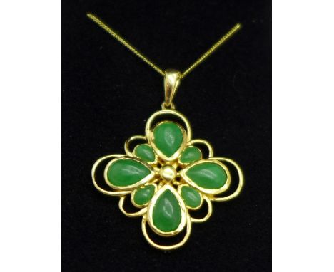 A silver gilt and jade pendant