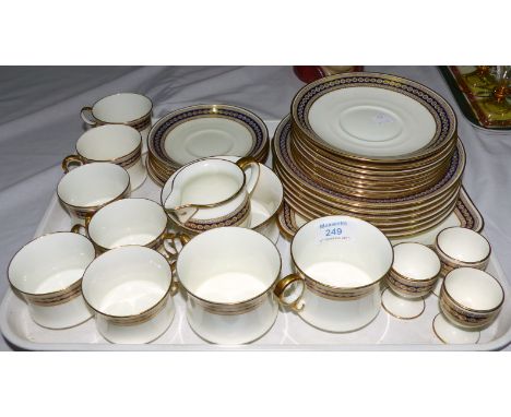 A Cauldon blue and gilt bordered 6 setting dinner and tea service, 36 pieces approx