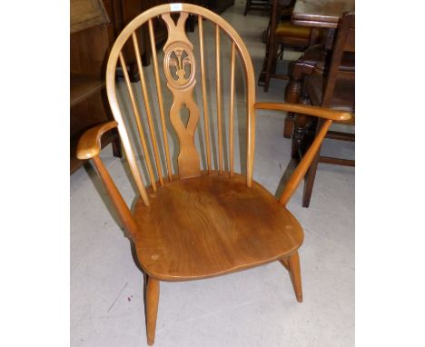 An Ercol lightwood low seat armchair