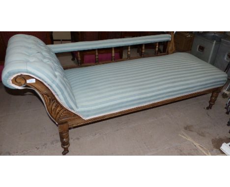 An Edwardian stained frame chaise longue in light blue striped fabric