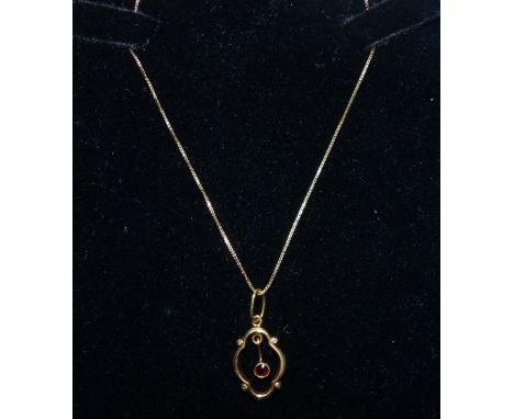 A vintage 9 carat hallmarked gold garnet pendant on 9 carat chain