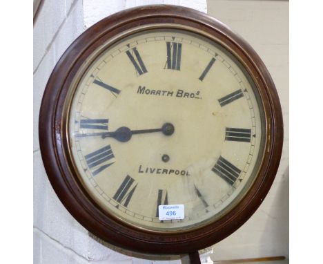 A spring driven wall clock with white enamel dial, mahogany case