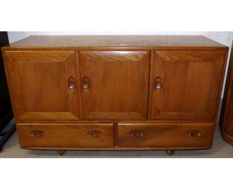 An Ercol light elm sideboard of 3 cupboards