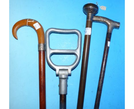 Three silver mounted walking sticks; an aluminium shooting stick