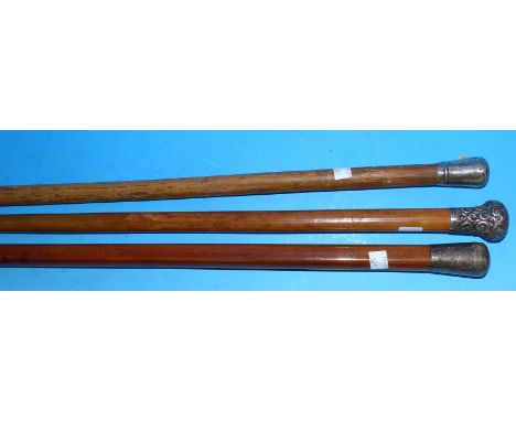 Three vintage walking sticks with silver tops