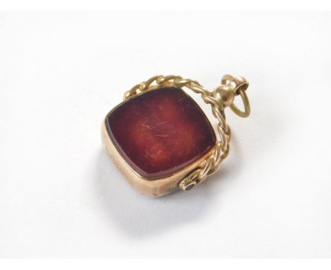 WATCH CHAIN FOB. A 9ct. gold mounted swivel fob set with cornelian.  Please note that all items in this auction are previousl