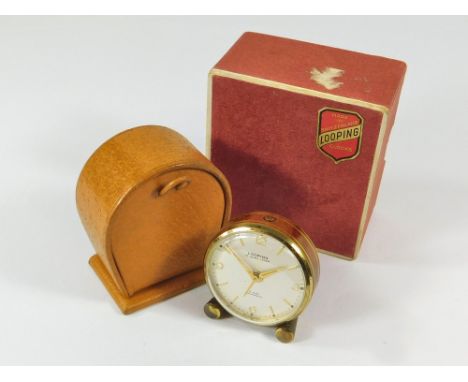 TRAVEL CLOCK. A Swiss Looping travel alarm clock in brown & gilt lacquered case. Leather carrying case & outer box.  All watc