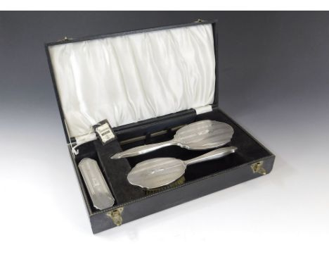 BRUSH SET. A 1960's four-piece brush set, the comb mount lacking a comb. Fitted case.  Please note that all items in this auc