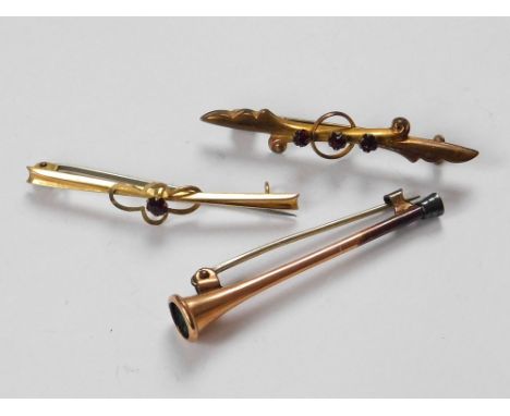 GOLD PIN ETC. A 9ct. gold bar brooch set a single garnet. Also, one other bar brooch & a rolled gold hunting horn pin.  Pleas
