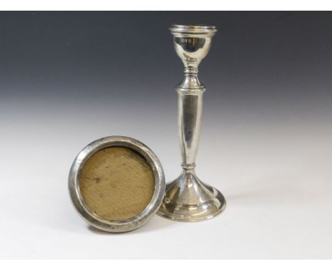 CANDLESTICK & FRAME. A mid 1940's filled silver candlestick, height 23cm. Also, a Chester silver photograph frame, lacks glas