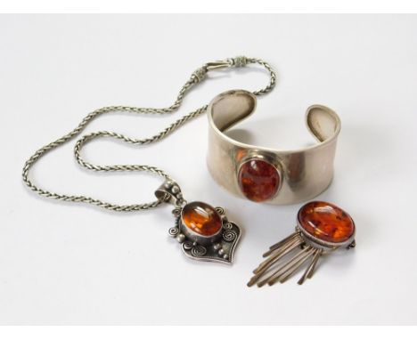 SILVER & AMBER. A silver & amber pendant & chain by Suarti. Also, a Mexican silver & amber bangle & a Mexican silver & amber 