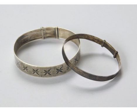 SILVER BANGLES. A 1970s star cut silver bangle & a child's expanding silver bangle.  Please note that all items in this aucti