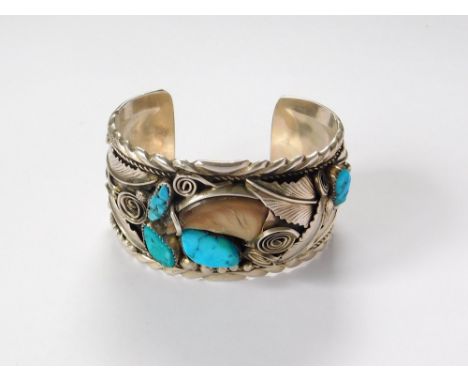 STERLING SILVER BANGLE. A North American Indian style, sterling silver cuff bangle, set with turquoise & a horn claw.  Please