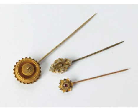 STICK PINS. A 9ct. gold, garnet set stick pin & two other 19th century stick pins. Longest, 8cm.  Please note that all items 