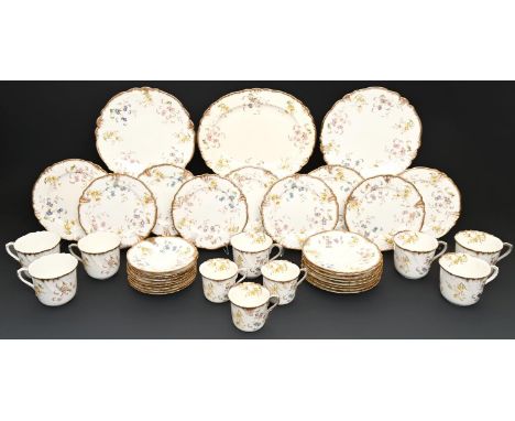 A Wileman &amp; Co shell moulded bone china tea and breakfast service, c1900, printed and painted with flowers, the rim and h