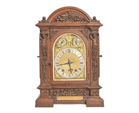 A German carved oak bracket clock, c1890, with Winterhalder &amp; Hofmeier movement striking on two gongs, in breakarched cas