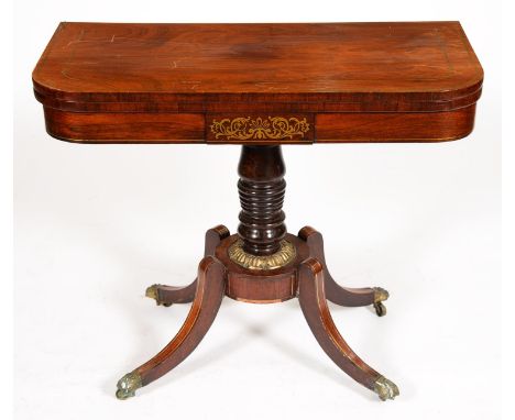 A George IV brass inlaid rosewood card table, on ring turned pillar, round platform with brass calyx and quadruple legs, paw 