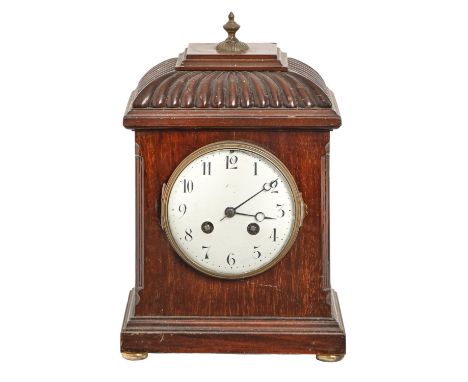 A mahogany basket-topped mantle clock, early 20th c, with enamel dial and French gong striking movement, 26cm h  Spattered wi