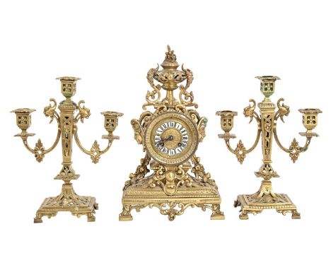 A French brass garniture de cheminee, late 19th c, openwork design, the clock with drum cased movement striking on a bell, 38