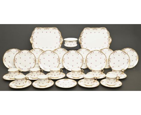 A Cauldon bone china tea service, c1910, of waisted shape, printed and painted with scattered roses and gilt, the service inc