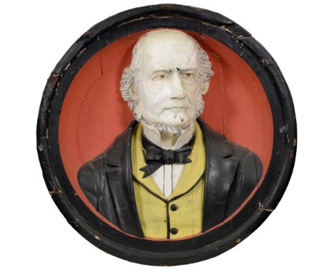 A Victorian carved and painted wood life-sized portrait relief of William Ewart Gladstone, integral frame, 79cm diam Chipped 