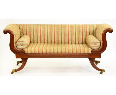 A Victorian mahogany scroll-end sofa, brass paw castors, with matching bolsters, 193cm l  Legs scratched and frame slightly s