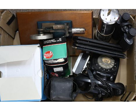 A mounted model of a hot air engine, a Davy lamp, a vintage telephone, binoculars and cameras, etc  