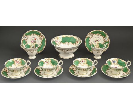 An English porcelain tea and coffee service, c1850, painted in a bright palette with flowers in vivid green and gilt border, 
