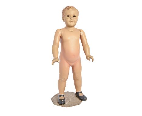 Advertising. A painted plaster shop window child mannequin, mid 20th c, with hazel glass eyes, steel stand, 82cm h  Slightly 