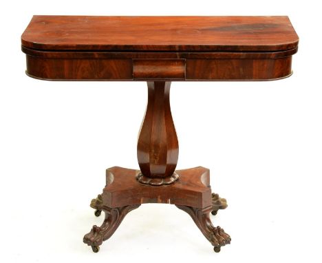 An early Victorian mahogany card table, with octagonal baluster pillar, platform and carved paw feet, on castors, 75cm h; 45 