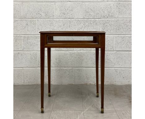 A late 19th century mahogany display table vitrine having a rectangular crossbanded case glazed on all sides and raised on fo