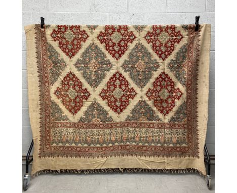 A large Persian hand dyed textile having a latticework field of scrolling geometric duck egg and iron red diamond lozenges wi