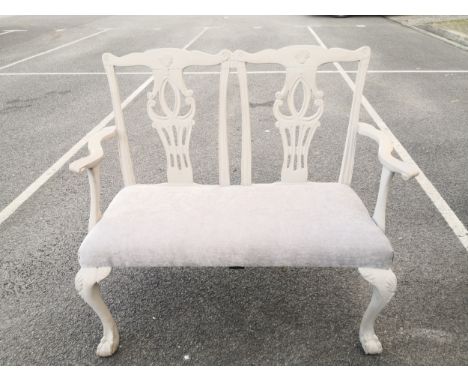 A 20th century Chippendale style painted two seater hall bench having a shaped top rail over two carved and pierced splats wi