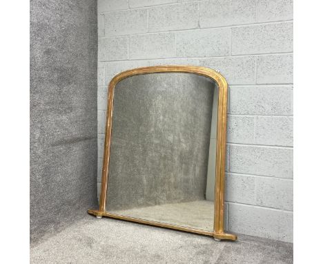 A large 19th century overmantel mirror having an arched plate in a moulded giltwood frame raised on a flat shaped plinth base