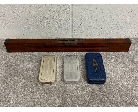 A collection of three early 20th century Rolls Razors along with an early 20th century brass mounted mahogany spirit level. L