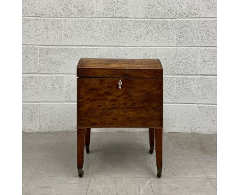 A Georgian mahogany cellarette having a hinged arched trunk top over the inlaid case with brass swan neck handless to each si