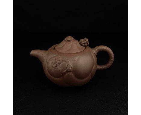 A 20th century Chinese Yixing Zisha clay 'Dragon Carp' teapot having a moulded lid with a cloud finial and a loose figural dr