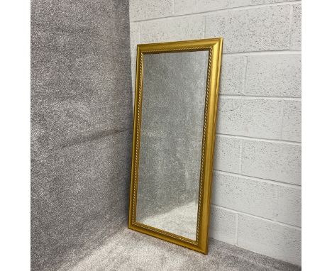 A contemporary wall mirror having a rectangular plate in a moulded giltwood surround. H.123.5 W.58cm