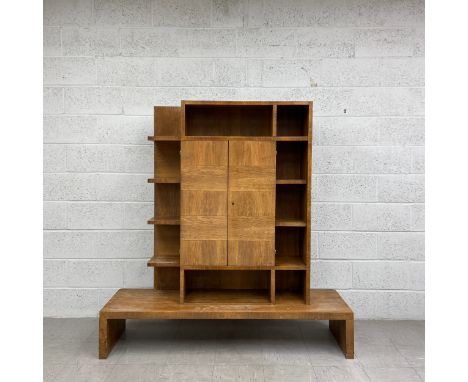 An early 20th century walnut Art Deco drinks or cocktail cabinet having a superstructure of twelve crossbanded shelves and al