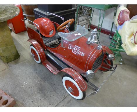 A child's fire engine pedal car
