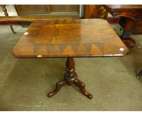 A Victorian rosewood and walnut octagonal tilt-top tripod table