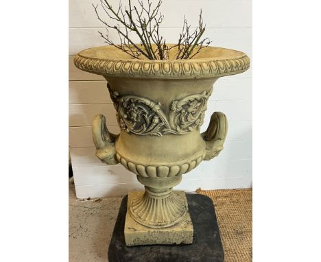 A garden urn planter with scrolling leaves and handles to side on a fluted stem to base (H82cm Dia63cm)